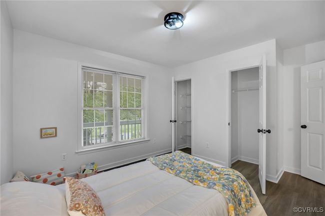 Bedroom featuring dark wood-style floors and baseboards | Image 19