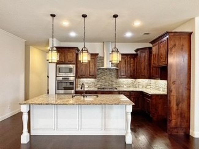 Kitchen with stainless steel appliances, wall chimney range hood, tasteful backsplash, dark wood finished floors, and recessed lighting | Image 6