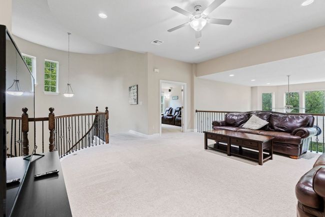 Carpeted living room with healthy amount of natural light, ceiling fan, recessed lighting, and baseboards | Image 23