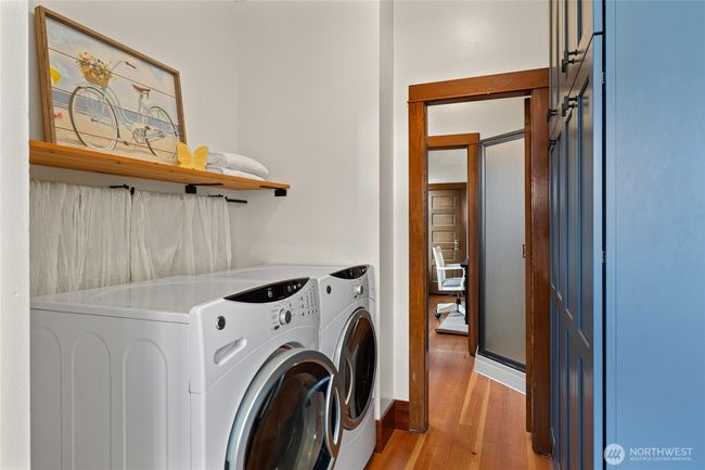 Laundry room features floor to ceiling stylish storage space. | Image 16