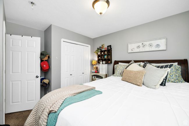 Carpeted bedroom with a closet | Image 20