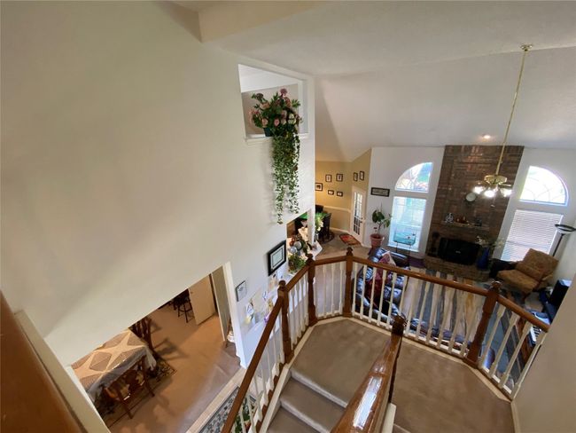 Stairway with ceiling fan, a fireplace, and high vaulted ceiling | Image 8