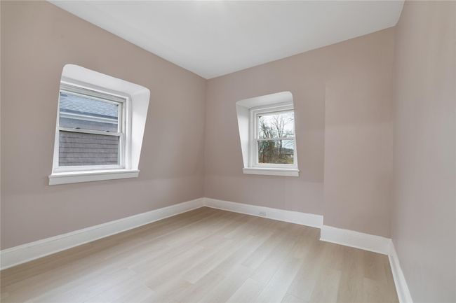 Empty room with baseboards and light wood finished floors | Image 14