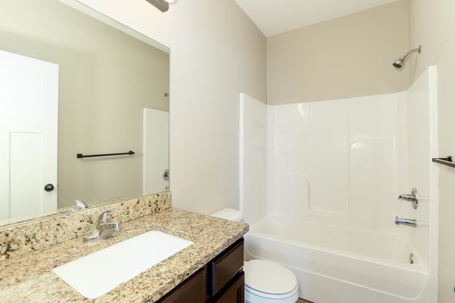 Full bathroom with vanity, toilet, and tub / shower combination | Image 18