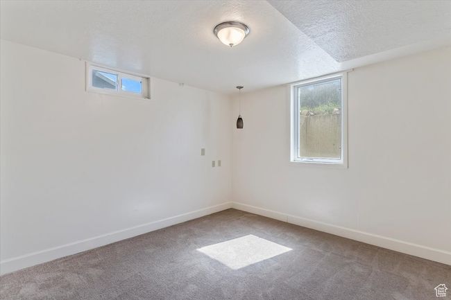 Unfurnished room with carpet and a textured ceiling | Image 32