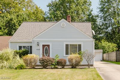 View of front of home with a front yard and a garage | Image 1