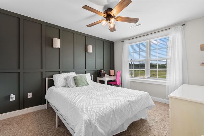 Bedroom featuring light colored carpet and a ceiling fan | Image 23