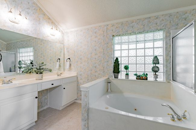 Bathroom with vanity, tile patterned flooring, ornamental molding, and a healthy amount of sunlight | Image 24