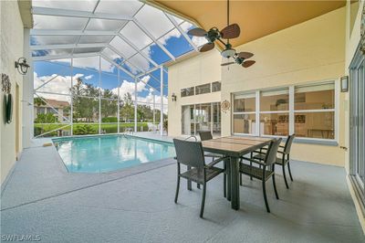 View of swimming pool featuring ceiling fan, a patio area, and a lanai | Image 3