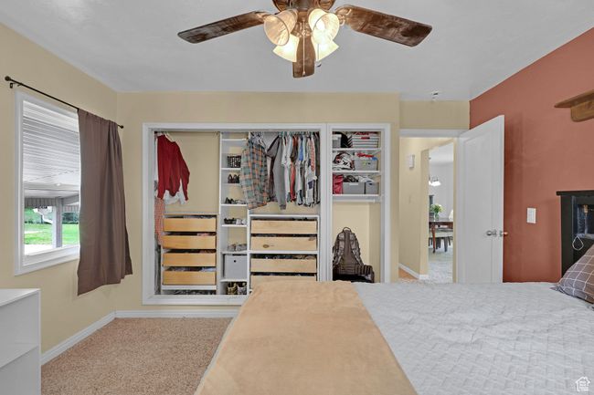 Bedroom with carpet flooring, baseboards, and a ceiling fan | Image 19