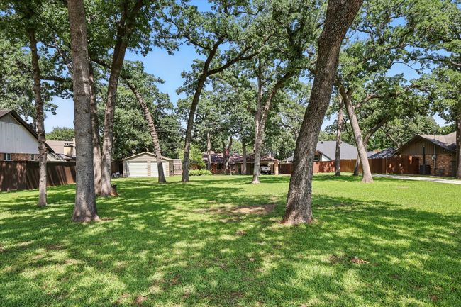 View of yard with a garage and an outbuilding | Image 34