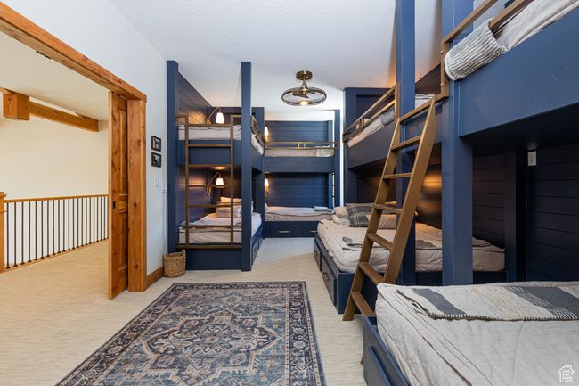 Carpeted bedroom with beam ceiling | Image 15
