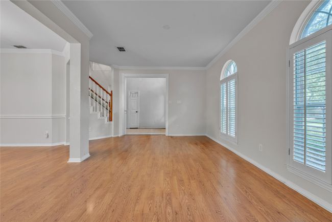 Entrance foyer featuring plenty of natural light, light wood-type flooring, stairway, and ornamental molding | Image 12