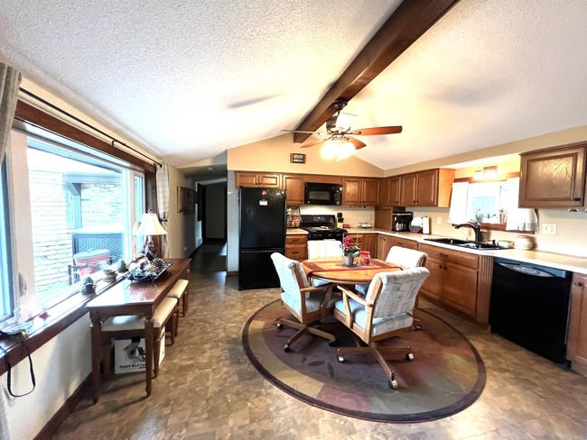 The spacious kitchen is the beginning of the original full log side of the home | Image 10