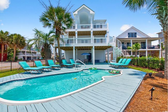 View of swimming pool featuring stairs, a patio area, and a wooden deck | Image 35