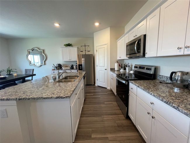 With white shaker style cabinets & granite counters this space screams modern! | Image 13