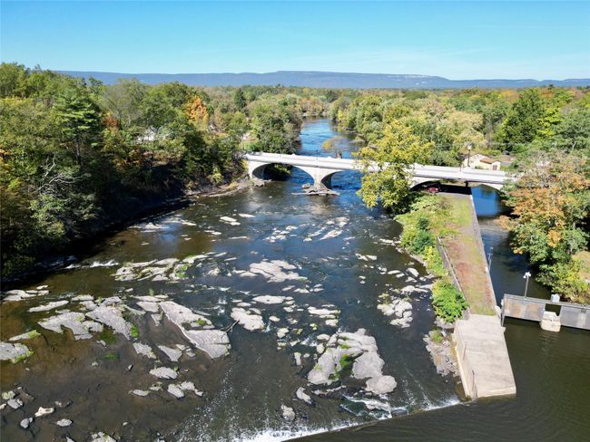 Drone / aerial view with a water view and a wooded view | Image 22