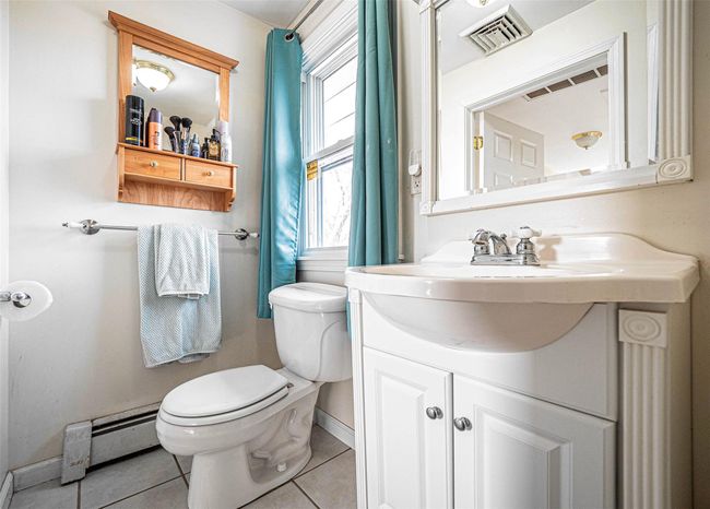 Bathroom on 2nd floor with tile patterned flooring, vanity, toilet, and a baseboard heating unit | Image 13