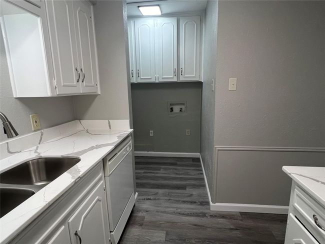 Laundry room featuring cabinet space, dark wood finished floors, and hookup for a washing machine | Image 8