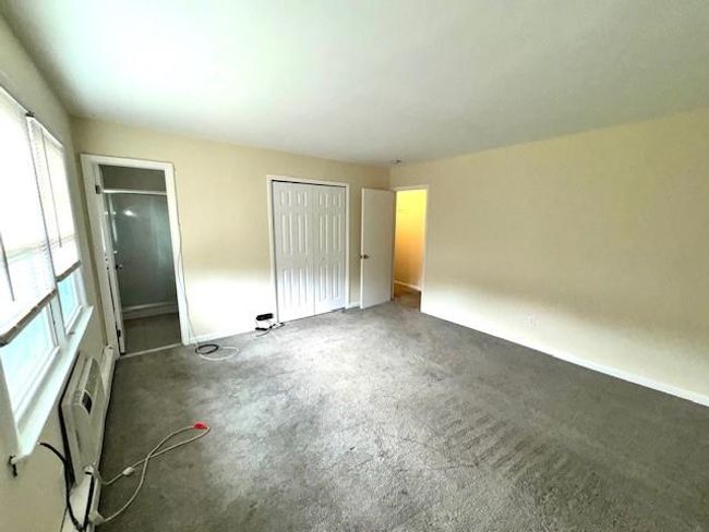Unfurnished bedroom featuring baseboards, carpet flooring, and a closet | Image 7