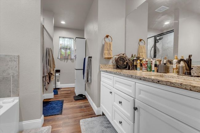 Bathroom with vanity, a stall shower, wood finished floors, a bath, and recessed lighting | Image 15