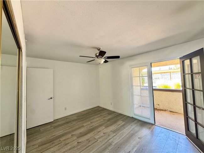 Spare room with a textured ceiling, wood finished floors, and ceiling fan | Image 26