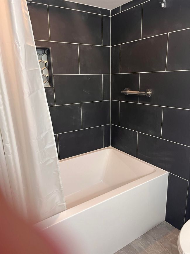 Bathroom featuring shower / bath combination with curtain and toilet | Image 14