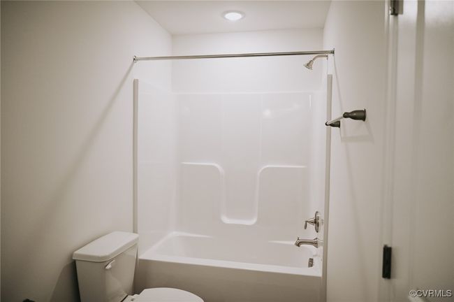 Bathroom featuring shower / tub combination and toilet | Image 17
