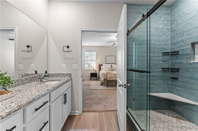 Ensuite bathroom with a stall shower, wood finished floors, vanity, and a ceiling fan | Image 34