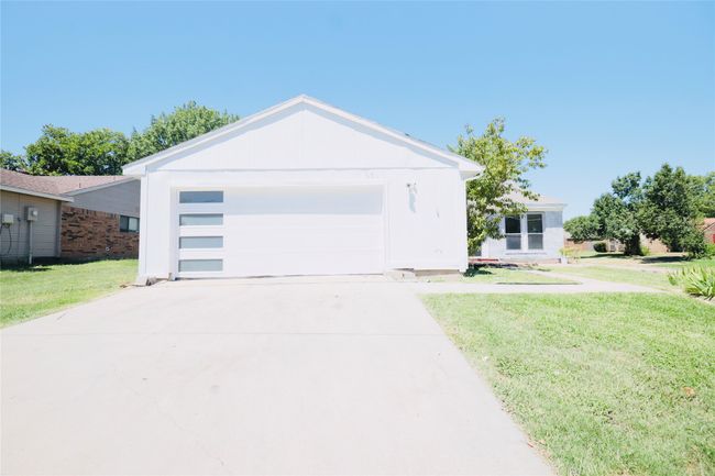 View of front of house featuring a garage, a front yard, and concrete driveway | Image 36