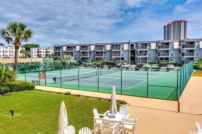 View of tennis court featuring a lawn | Image 26