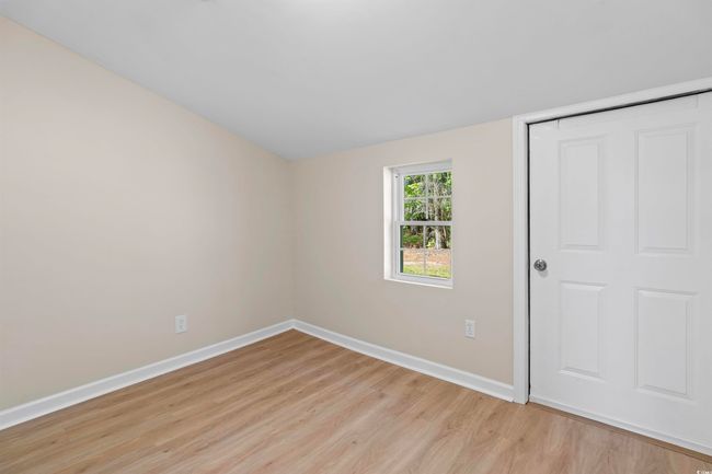 Unfurnished bedroom with light wood-style floors and a closet | Image 38