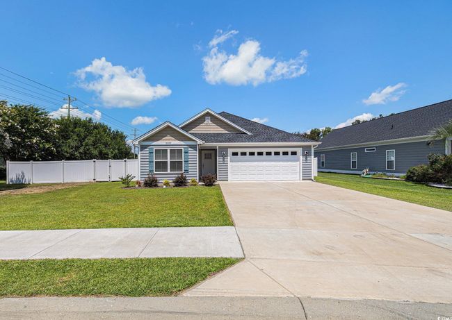Ranch-style home with concrete driveway and a garage | Image 28