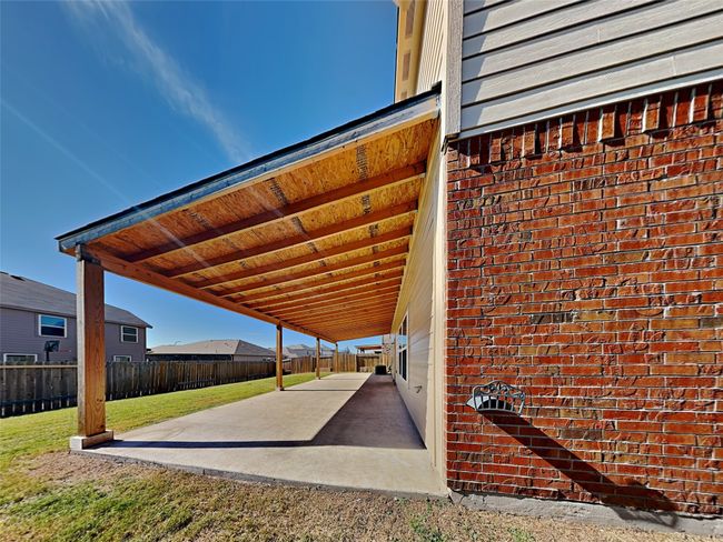 Fenced backyard with a patio area | Image 18