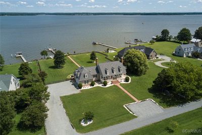 Aerial showing 1.7 acres of riverfront property. Side entry 2 car garage. | Image 1