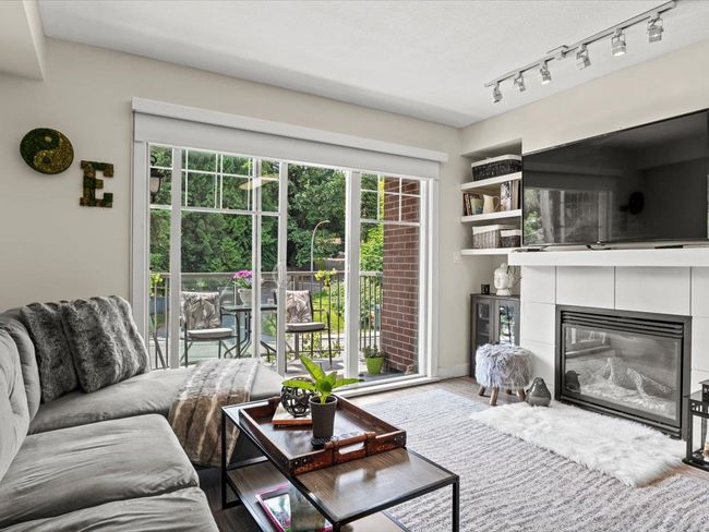 Living area featuring a tile fireplace | Image 4