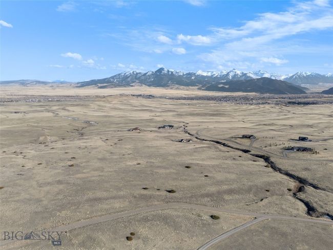 Real Estate Sign is near the two bushes in the middle of the photo, south side of the road | Image 26