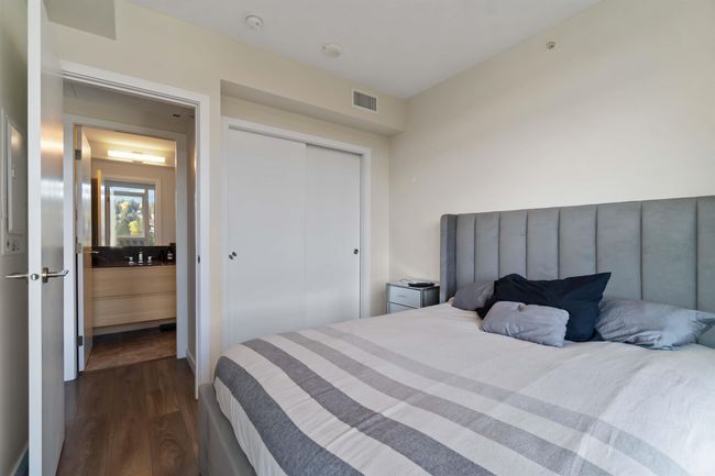 Bedroom with dark wood-style floors, a closet, and visible vents | Image 18
