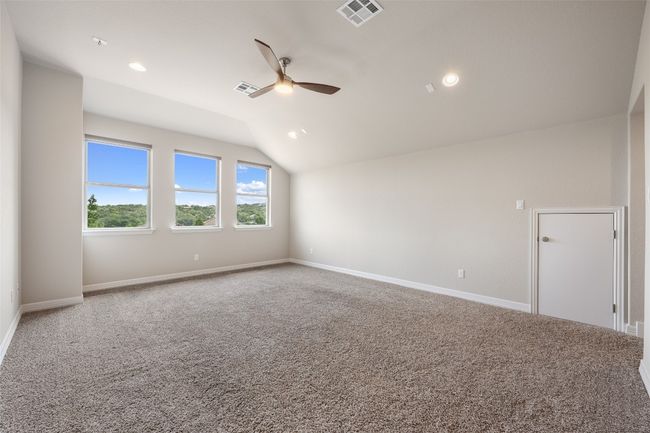 Empty room featuring vaulted ceiling, a ceiling fan, carpet flooring, and recessed lighting | Image 24