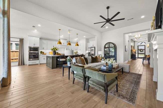 Living room with a ceiling fan, light wood-style flooring, and recessed lighting | Image 17