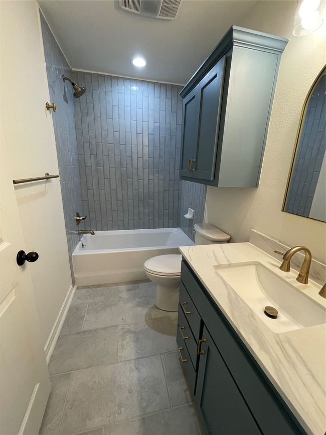 Bathroom with recessed lighting, visible vents, toilet, vanity, and shower / tub combination | Image 14