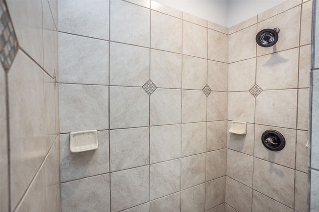 Bathroom featuring a tile shower | Image 27