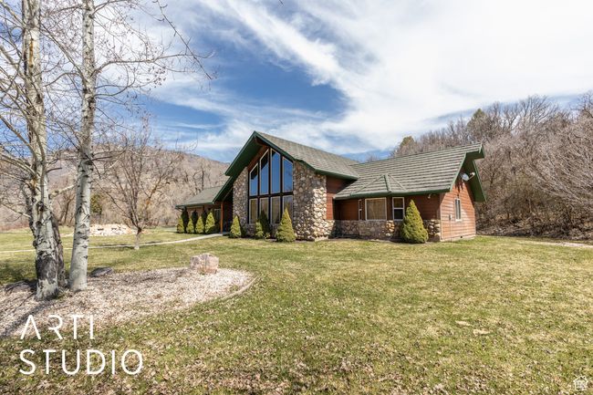 View of side of home with a yard and stone siding | Image 11