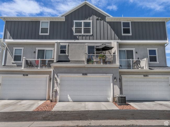 View of the property featuring an attached garage, stucco siding, board and batten siding, and a balcony | Image 36