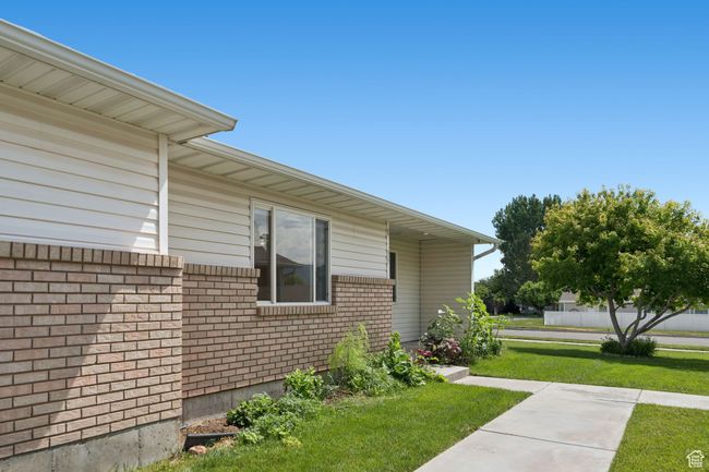 View of property exterior featuring a lawn and brick siding | Image 23