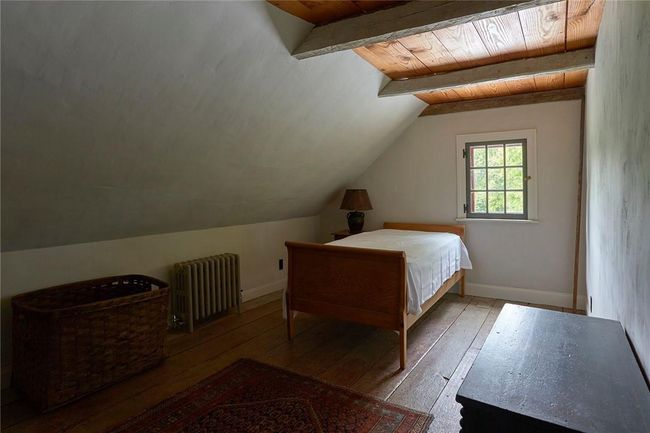 Bedroom with wood ceiling, hardwood / wood-style flooring, radiator, and lofted ceiling with beams | Image 13