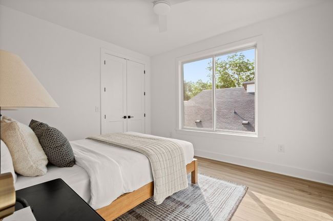 Bedroom featuring a closet, ceiling fan, baseboards, and wood finished floors | Image 10