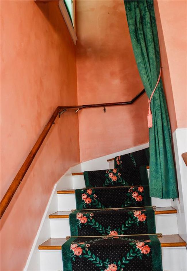 The grand staircase, with a customized stairway area rug, to bring you to three upstairs bedrooms and a bonus room | Image 23