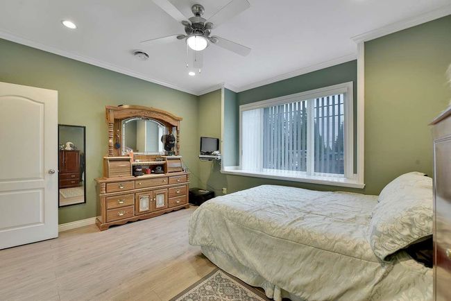 Bedroom with wood finished floors, crown molding, recessed lighting, baseboards, and a ceiling fan | Image 30