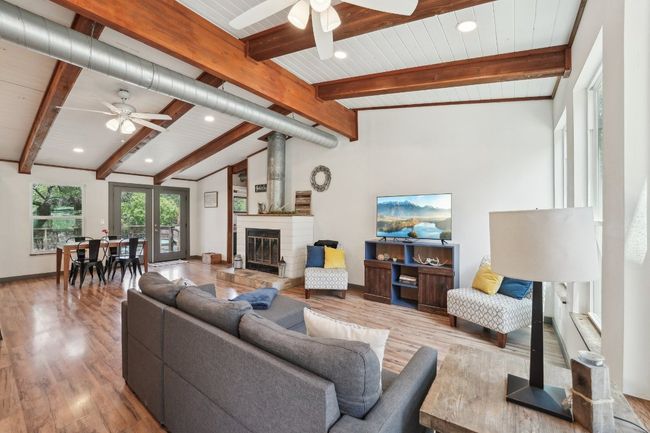 Living area featuring ceiling fan, wood finished floors, recessed lighting, and a fireplace | Image 5
